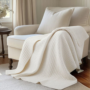 Loden reversible throw blanket in cream and taupe, machine washable, perfect for adding texture and warmth to any room.