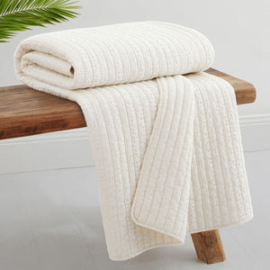 Reversible Loden throw featuring small-to-large waffle stripes on one side and solid cream on the back, perfect for couches or beds.