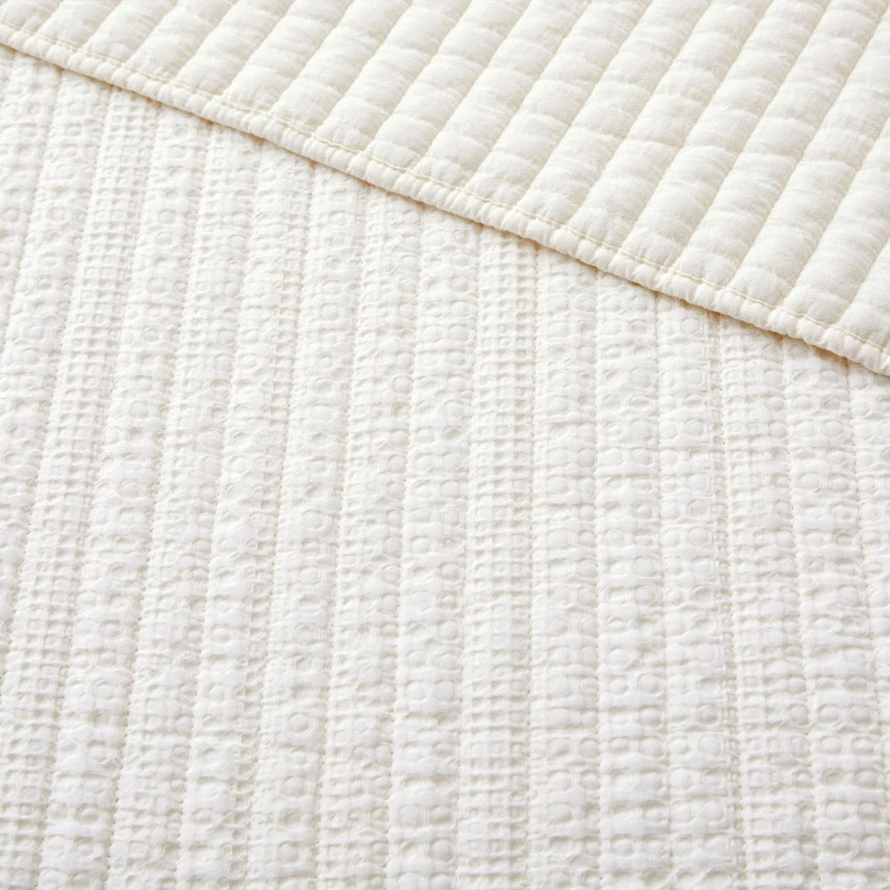 Loden throw blanket with waffle weave design, soft cotton front and back, ideal for cozy home décor.