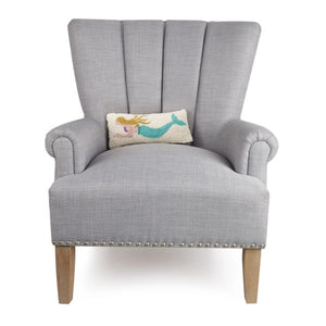 Decorative coastal lumbar pillow with mermaid motif set on chair