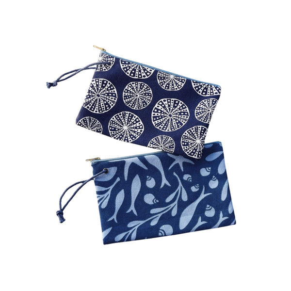 Soft cotton urchin wristlet with textured design and wrist strap, perfect for hands-free carrying of essentials.