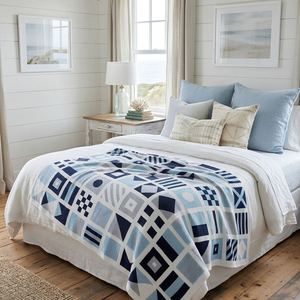 Navy, Light Blue, And Gray Nautical Flag Cotton Knit Throw Draped Across A White Bed, Nautical Bedroom Decor, Coastal Housewarming Gift