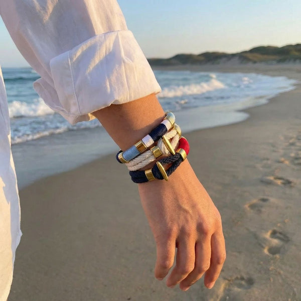 Coastal-inspired hand-dyed cotton rope bracelet with gold-plated details, perfect for layering.