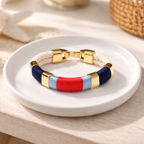 Coastal-inspired hand-dyed cotton rope bracelet with gold-plated details, perfect for layering.