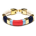 Coastal-inspired hand-dyed cotton rope bracelet with gold-plated details, perfect for layering.