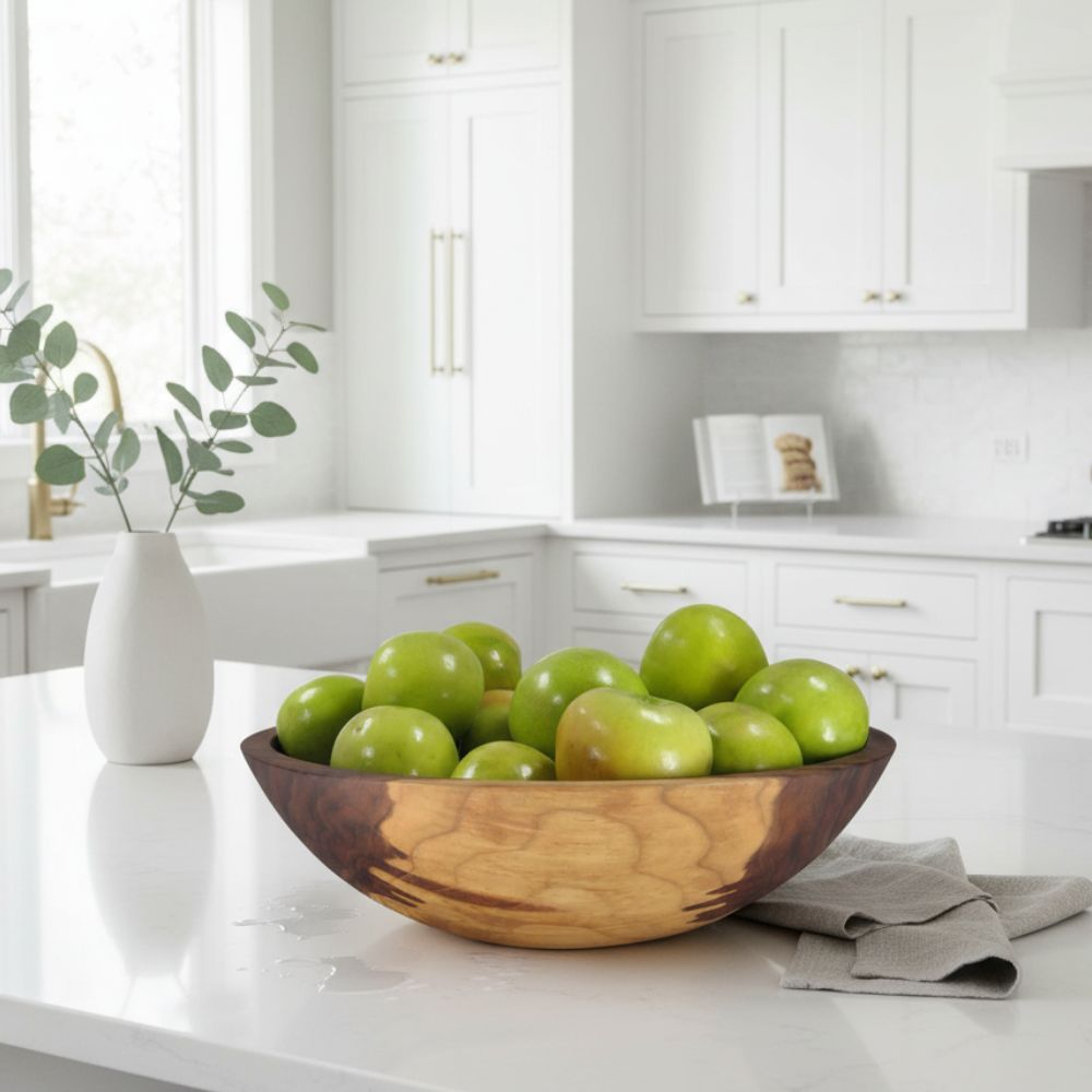Wooden bowl with green apples on a kitchen counter