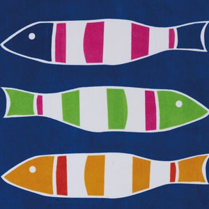 Close-up of colorful striped fish pattern on blue cotton beach towel