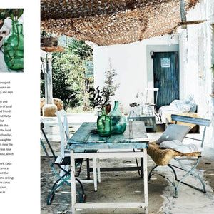 Outdoor patio with a table and chairs under a thatched roof