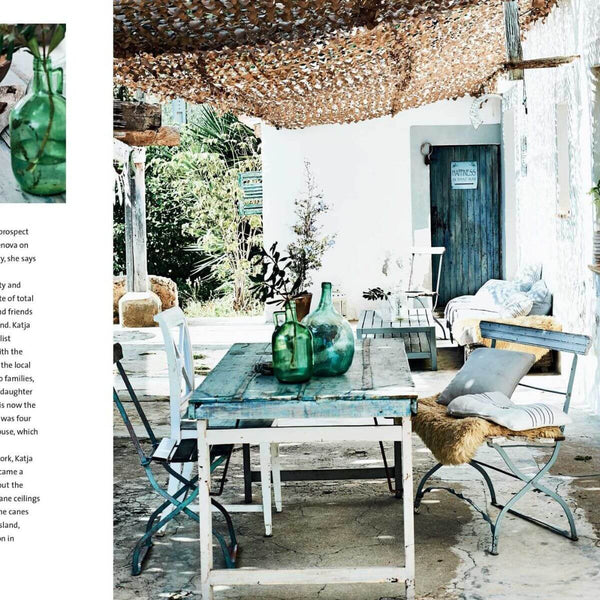 Outdoor patio with a table and chairs under a thatched roof