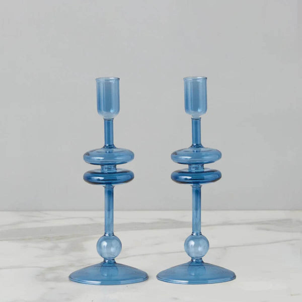 Two small sapphire blue glass candlesticks, adding a pop of color and coastal charm to any table, coastal home decor