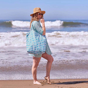 Large coastal-inspired tote made from durable cotton canvas, featuring self-fabric handles, inside zipper pocket, and magnetic snap for versatile use