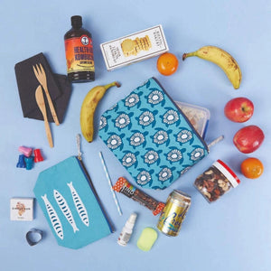 Coastal-inspired medium cotton canvas pouch with playful print, gold zipper, and printed looped pull, perfect for organizing essentials.