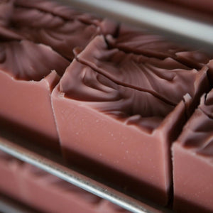 Handcrafted coastal bar soap in a pink shade from rose kaolin clay, offering a fresh berry and vanilla scent with a gentle, moisturizing lathe