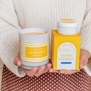 Hand-poured Seaside Citrine® candle with bright citrus and sea notes in a white glass jar, perfect for coastal living.