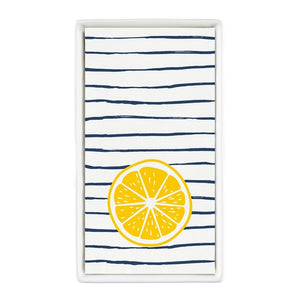 Striped lemon guest napkins displayed in a white ceramic napkin tray