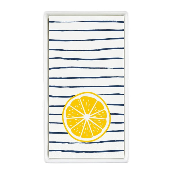 Striped lemon guest napkins displayed in a white ceramic napkin tray