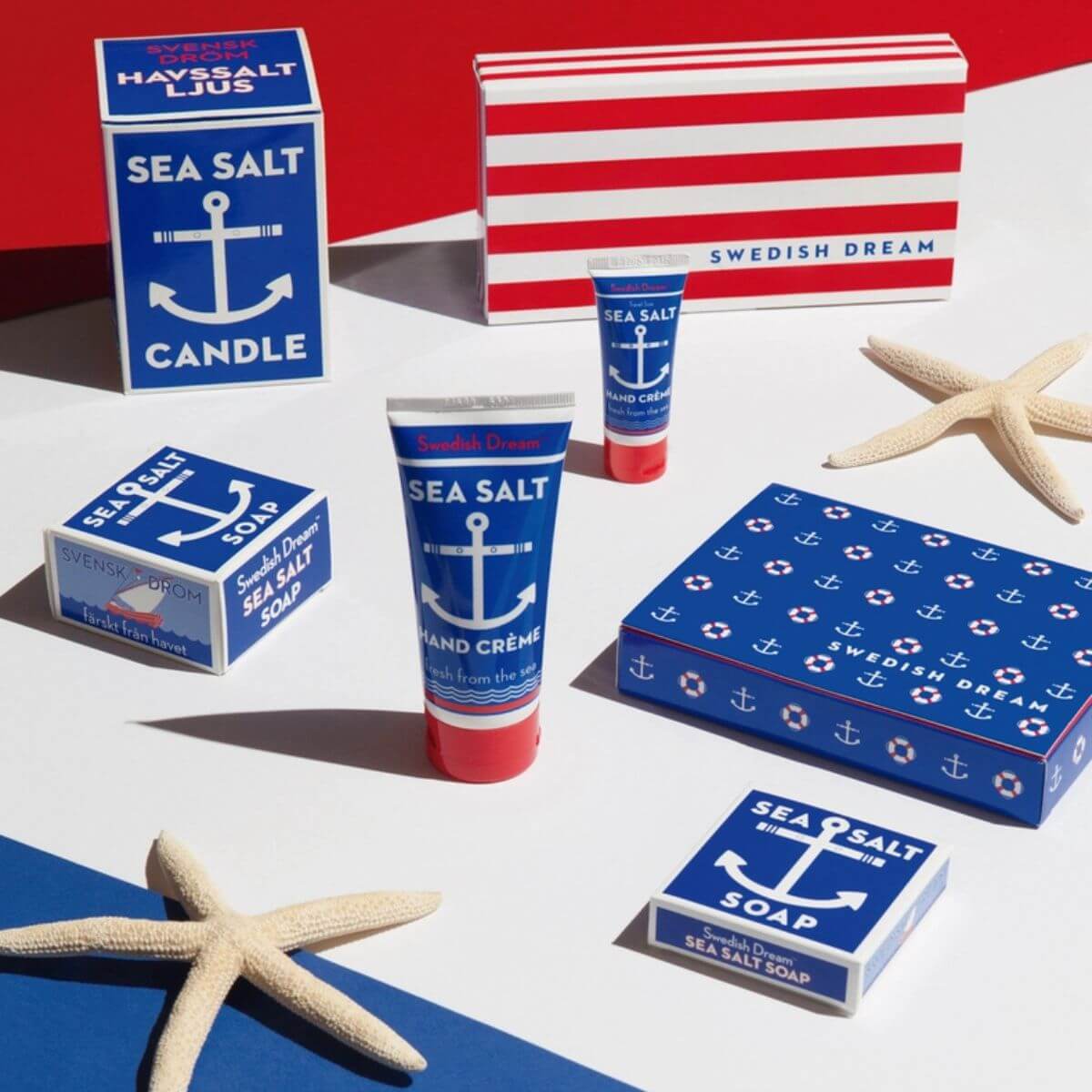Collection of Swedish Dream sea salt products including candles, soap, and hand cream on a red, white, and blue background.