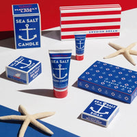 Thumbnail for Collection of Swedish Dream sea salt products including candles, soap, and hand cream on a red, white, and blue background.