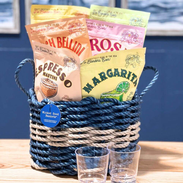 Coastal Cocktail Gift Basket featuring frozen drink mixes in a nautical blue with silver stripe lobster rope basket with personalized tumblers – perfect beach-themed cocktail gift for summer parties and seaside entertaining.