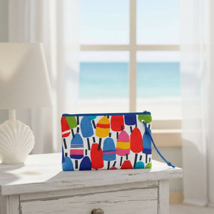 Colorful wristlet with buoy pattern and wrist strap, adding a nautical touch to everyday style