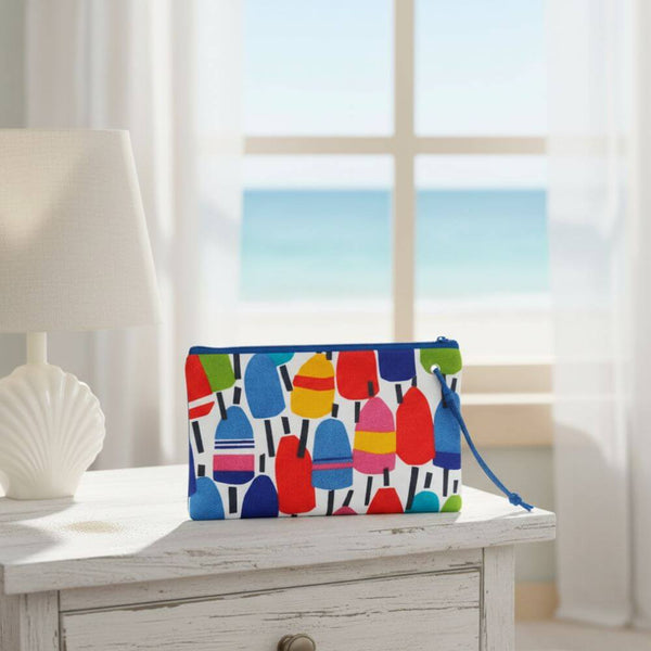 Colorful wristlet with buoy pattern and wrist strap, adding a nautical touch to everyday style