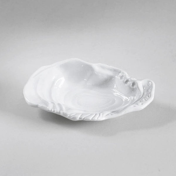 Small sculptural oyster shell bowl in white, heavy-weight melamine, indoor/outdoor friendly.