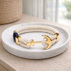 Coastal-inspired rope bracelet with textured cotton and gold anchor detail, ideal for everyday wear.