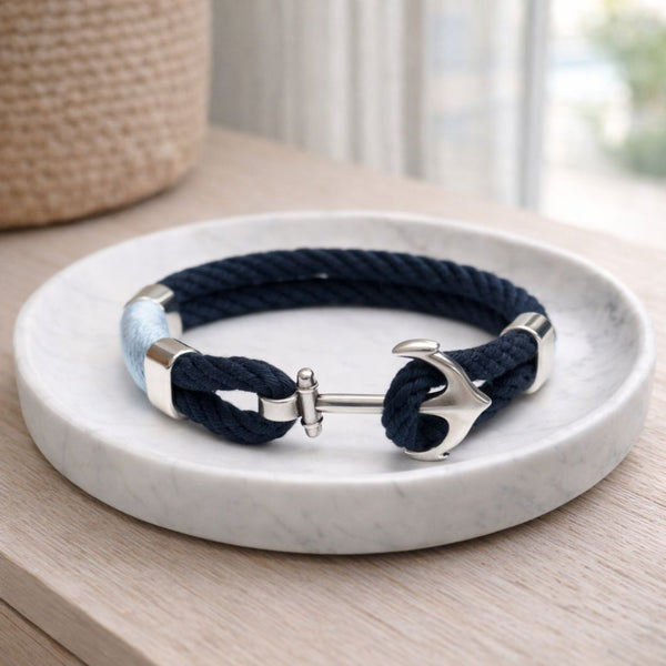 Handmade coastal cotton rope bracelet with silver-plated anchor clasp and spacer bead, inspired by nautical summer style.
