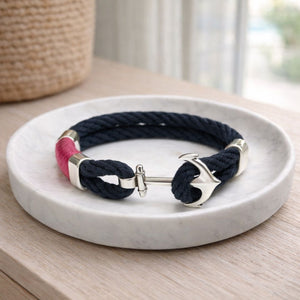 Handcrafted cotton rope bracelet with anchor clasp and silver-plated bead, evoking coastal memories and nautical style.