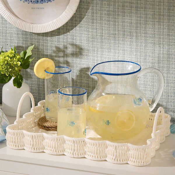 Durable wicker scallop tray set with handles for entertaining, drinks, or decorative display in beach-house kitchen.