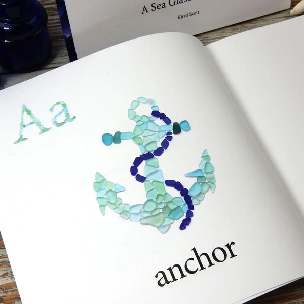 A To Sea Sea Glass Alphabet Book Open To Anchor Artwork, Beach Glass Mosaic And Coastal Alphabet Book