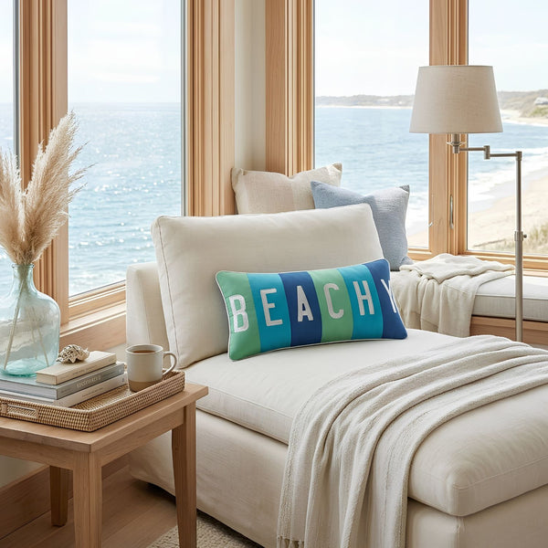 Beachy Coastal Throw Pillow With Embroidered White Lettering and Green, Teal, and Indigo Color Blocking Styled on a Cream Sofa, Coastal Throw Pillow for Beach House Decor