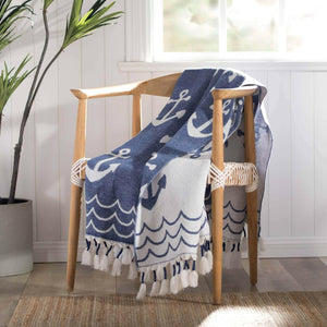 Blue and White Anchor Print Tassel Throw Draped Over a Wooden Accent Chair, Nautical Home Decor