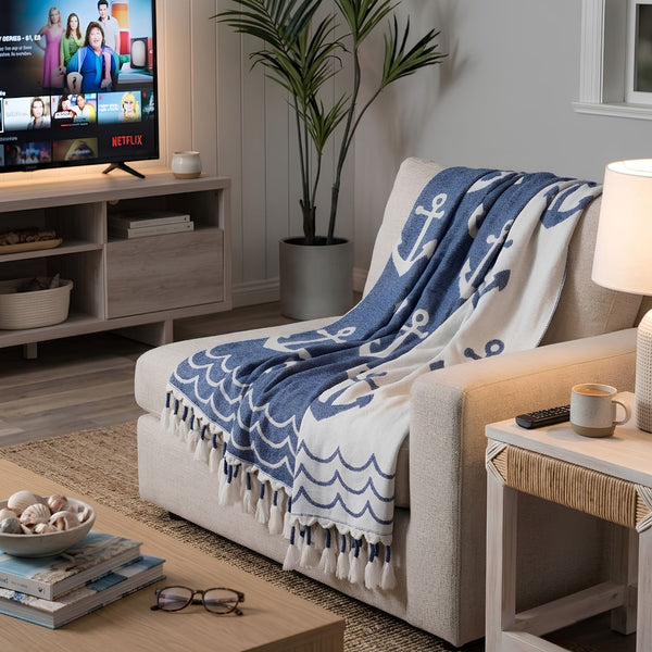 Blue and White Anchor Print Tassel Throw Draped Over a Neutral Sofa With Coastal Accents, Nautical Living Room Decor