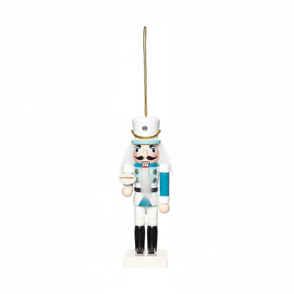 White and aqua coastal nutcracker ornament with hanging loop, featuring a round accessory, perfect for coastal living holiday décor.