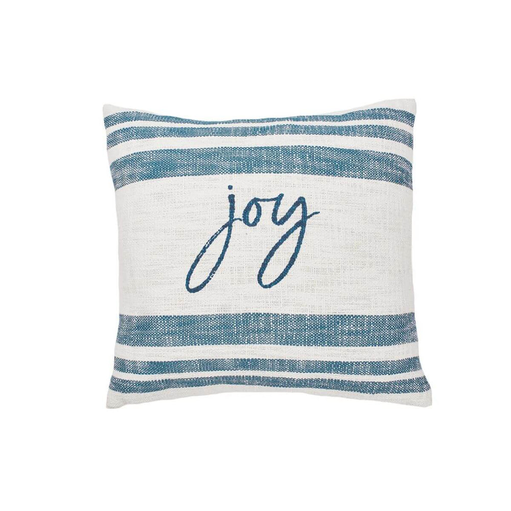 Indigo-striped cotton pillow with ‘Joy’ script, layered with natural textures and cozy accents for a relaxed, festive look.