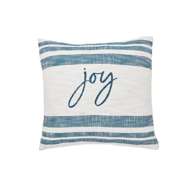 Indigo-striped cotton pillow with ‘Joy’ script, layered with natural textures and cozy accents for a relaxed, festive look.