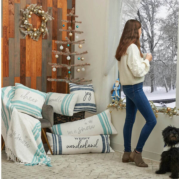 Square indigo-striped cotton pillow with ‘Joy’ lettering, perfect for coastal-inspired holiday décor and cozy seasonal layering.