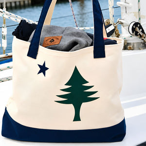Natural Canvas Maine Flag Tote Bag With Navy Straps On A Boat, Nautical Canvas Carryall And Coastal Gift