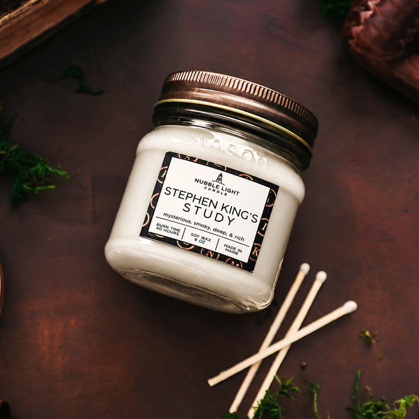 Nubble Light Candle Stephen King’s Study 8 oz Soy Wax Candle in White on a Rustic Dark Background with Matches, New England Candles, Literary Candles, Scented Jar Candles, Maine Candles