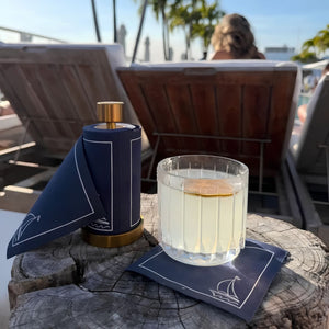 Sail Away Navy Cotton Cocktail Napkins Styled With A Drink For Coastal Tabletop Entertaining