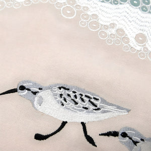 Closeup Of Embroidered Sandpiper Detail On Indoor Throw Pillow With Sea Green Wave Stitching, Coastal Home Decor And Beach House Pillows