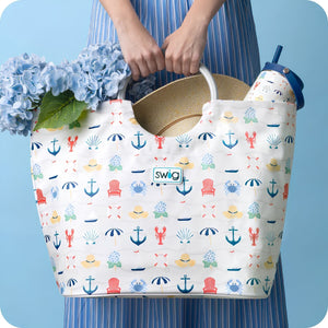 Shoreline Loopi Tote Bag With Coastal Nautical Print Holding Hydrangeas Beach Hat And Travel Tumbler